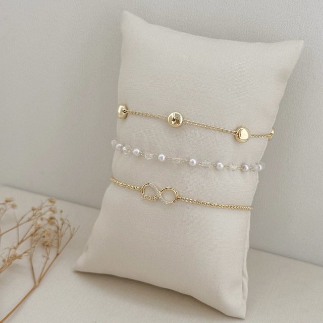 12.2113.15.O - Pulseira de bolinhas em resina pérola e resina cristal intercalados por inteiro