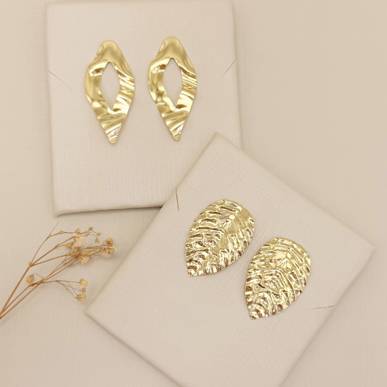 06.1326.0.O - Brinco formato navete com desenho vazado no centro em formato navete e detalhes amassados na chapa, brinco orgânico.