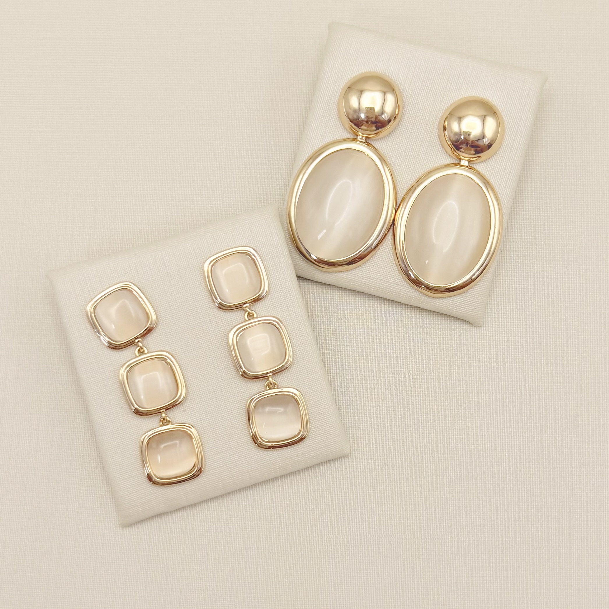 06.1351.15.O - Brinco com base circular lisa e pingente oval em madre pérola com borda lisa