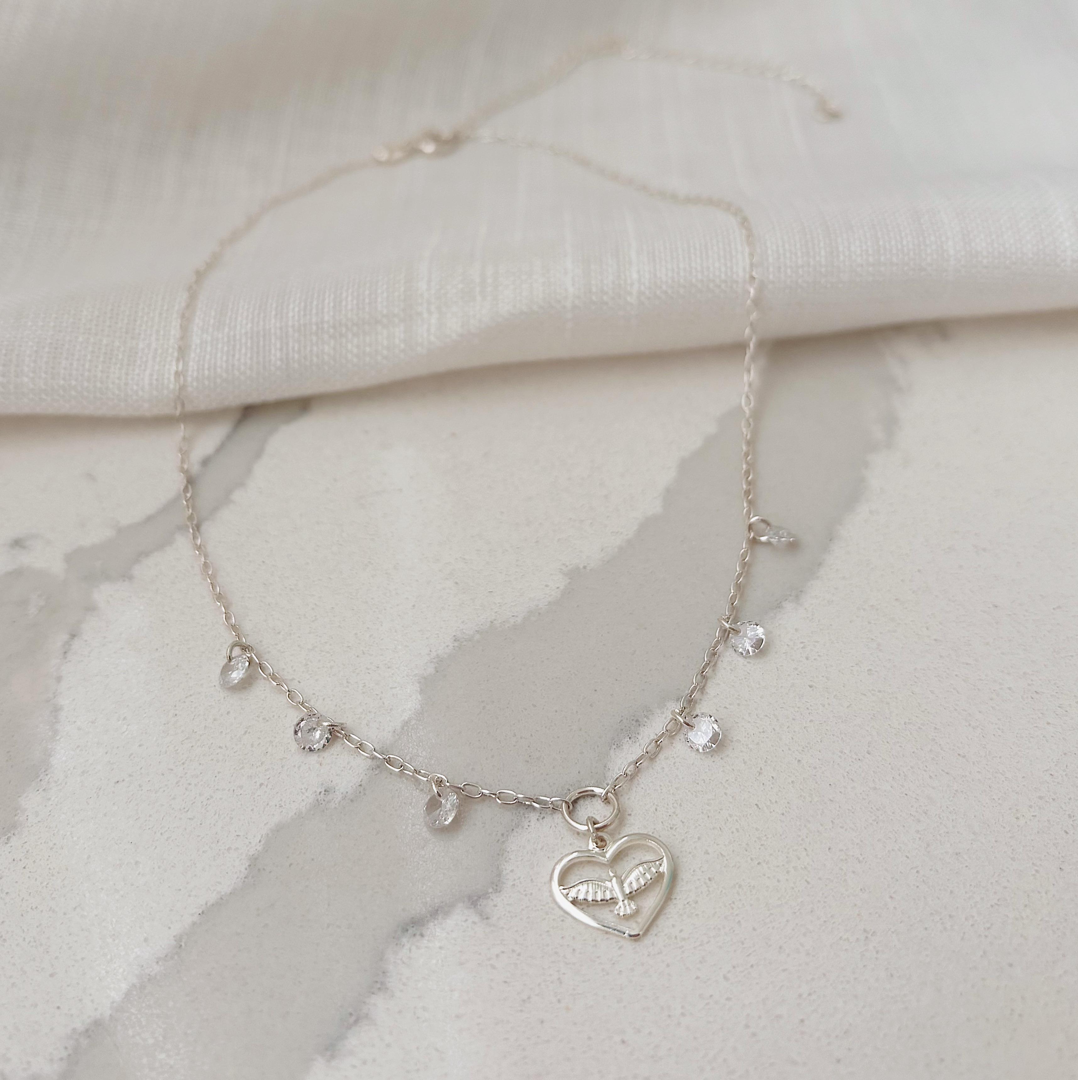 CHOKER CORAÇÃO COM ESPÍRITO SANTO E CRISTAIS. 35CM DE COMPRIMENTO E 10CM DE REGULAGEM. EM PRATA 925.