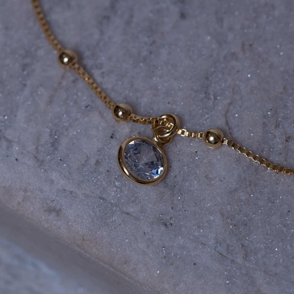 TORNOZELEIRA BOLINHAS COM PONTO DE LUZ BANHO OURO 18K