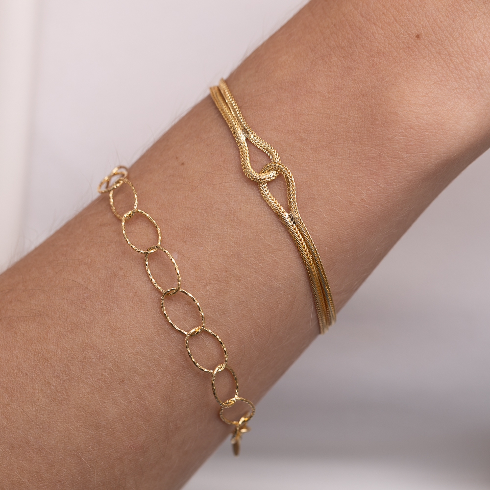 PULSEIRA FITA ENTRELAÇADA BANHO OURO 18K