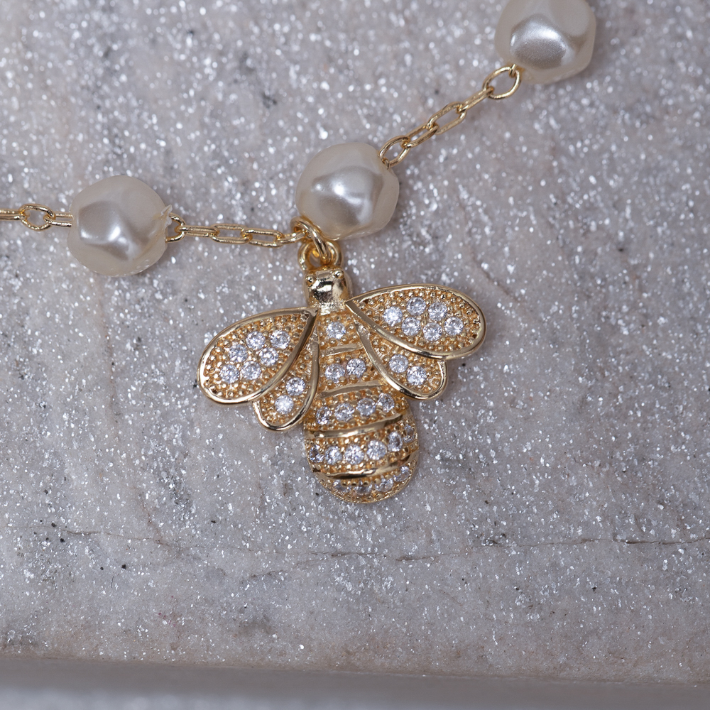 PULSEIRA PÉROLA COM LIBÉLULA CRAVEJADA BANHO OURO 18K