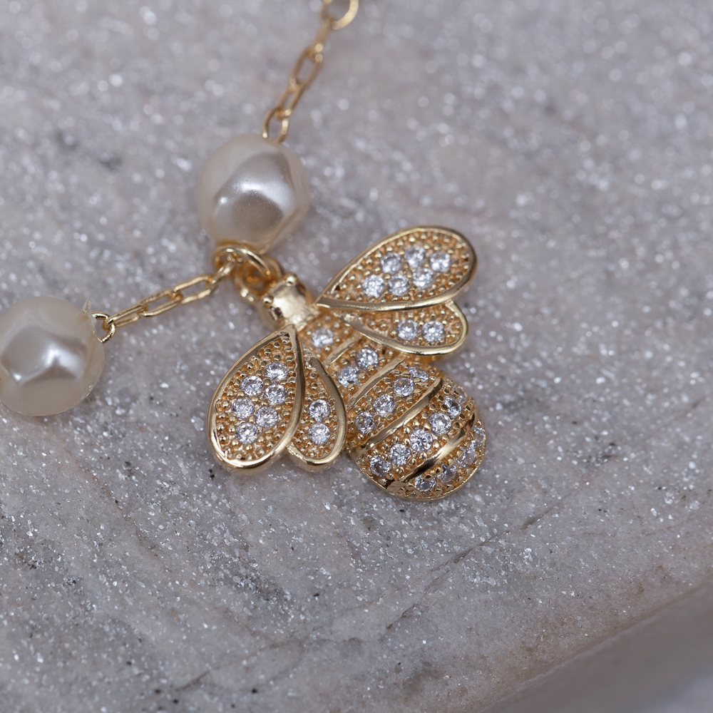 PULSEIRA PÉROLA COM LIBÉLULA CRAVEJADA BANHO OURO 18K