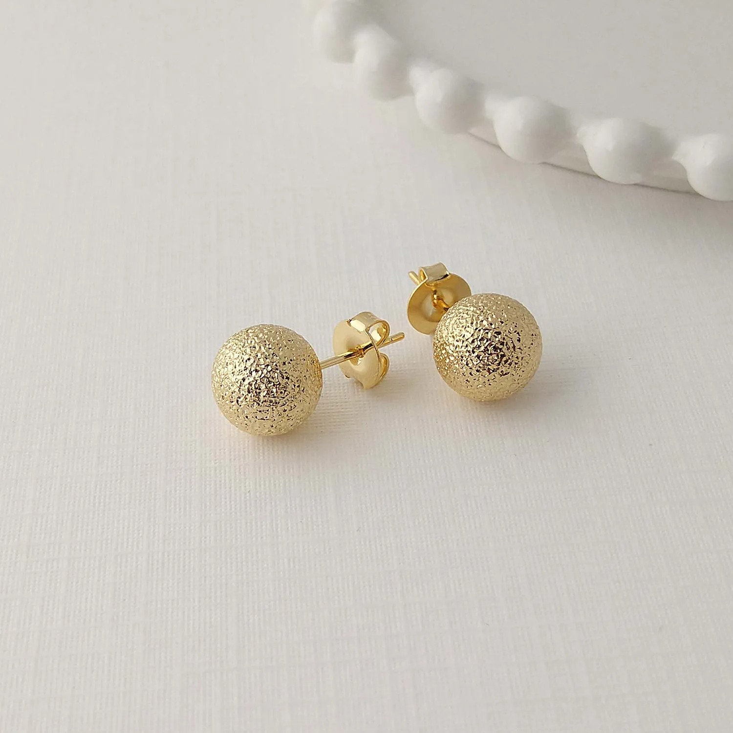 BRINCO BOLA LISA TEXTURIZADA - AURA